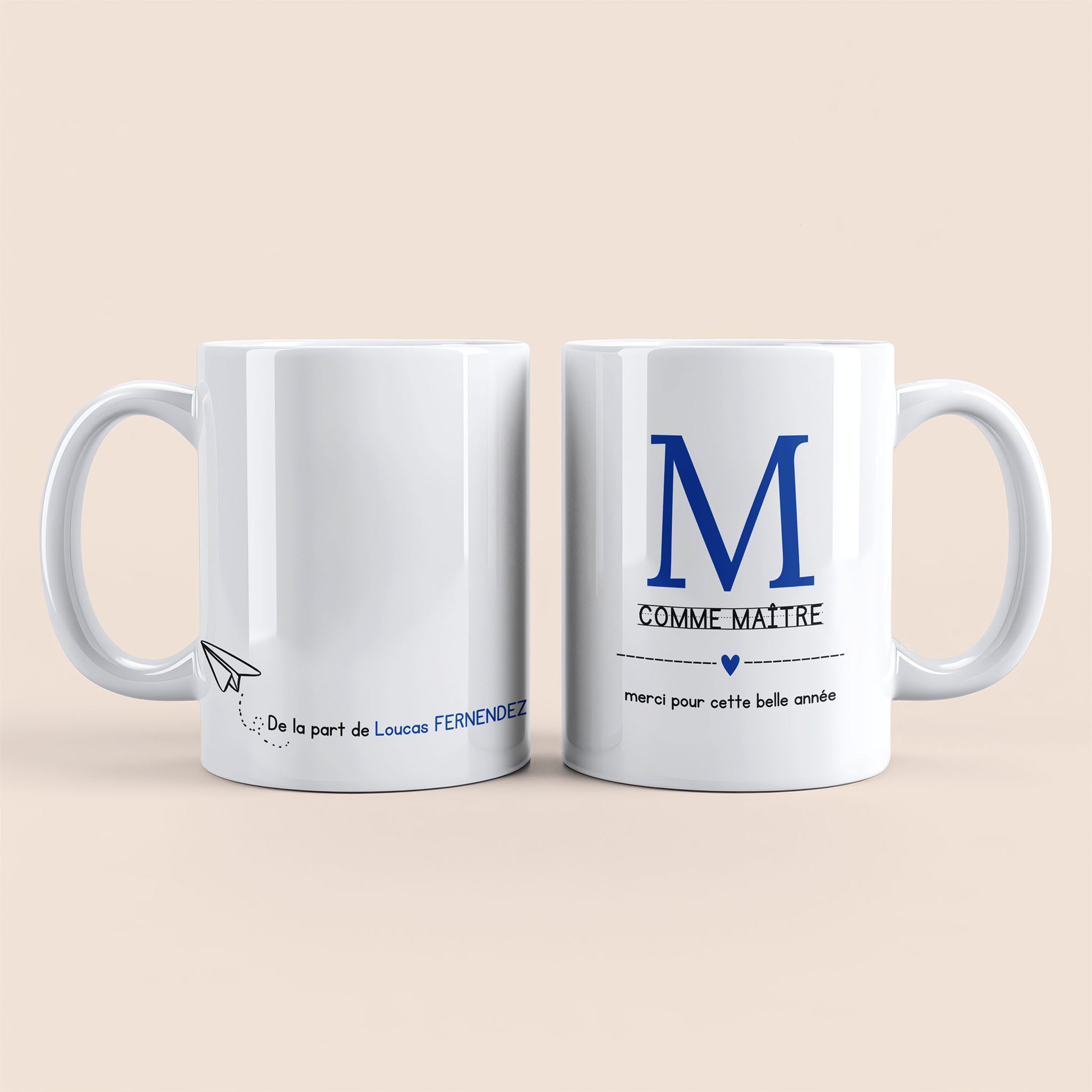 Mug blanc. Lettre M (maître) et un cœur bleu plus texte à droite. Texte personnalisé avec nom à gauche.